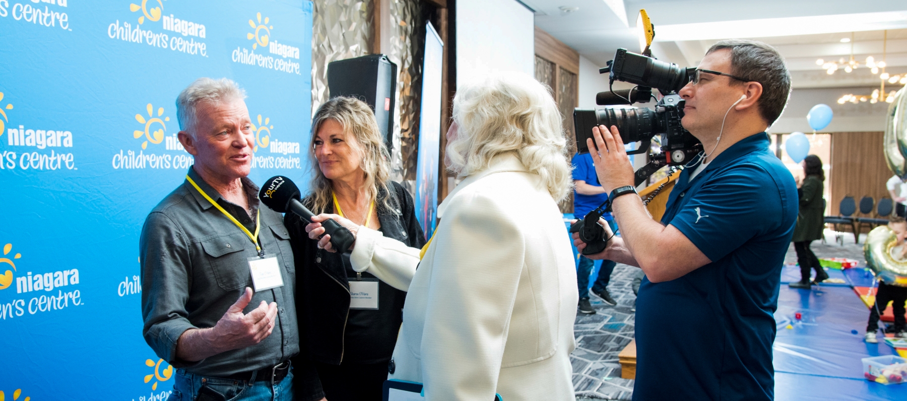 Man and women being interviewed by media at live event